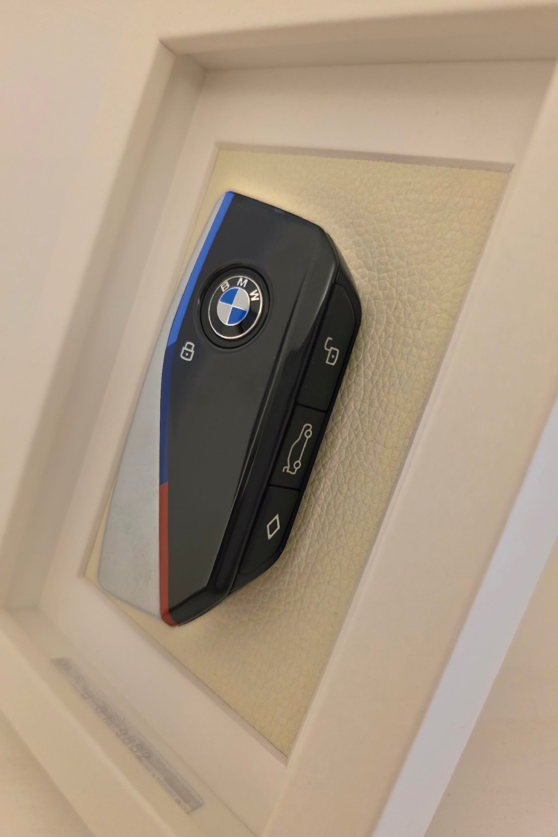 BMW key fob on a beige background